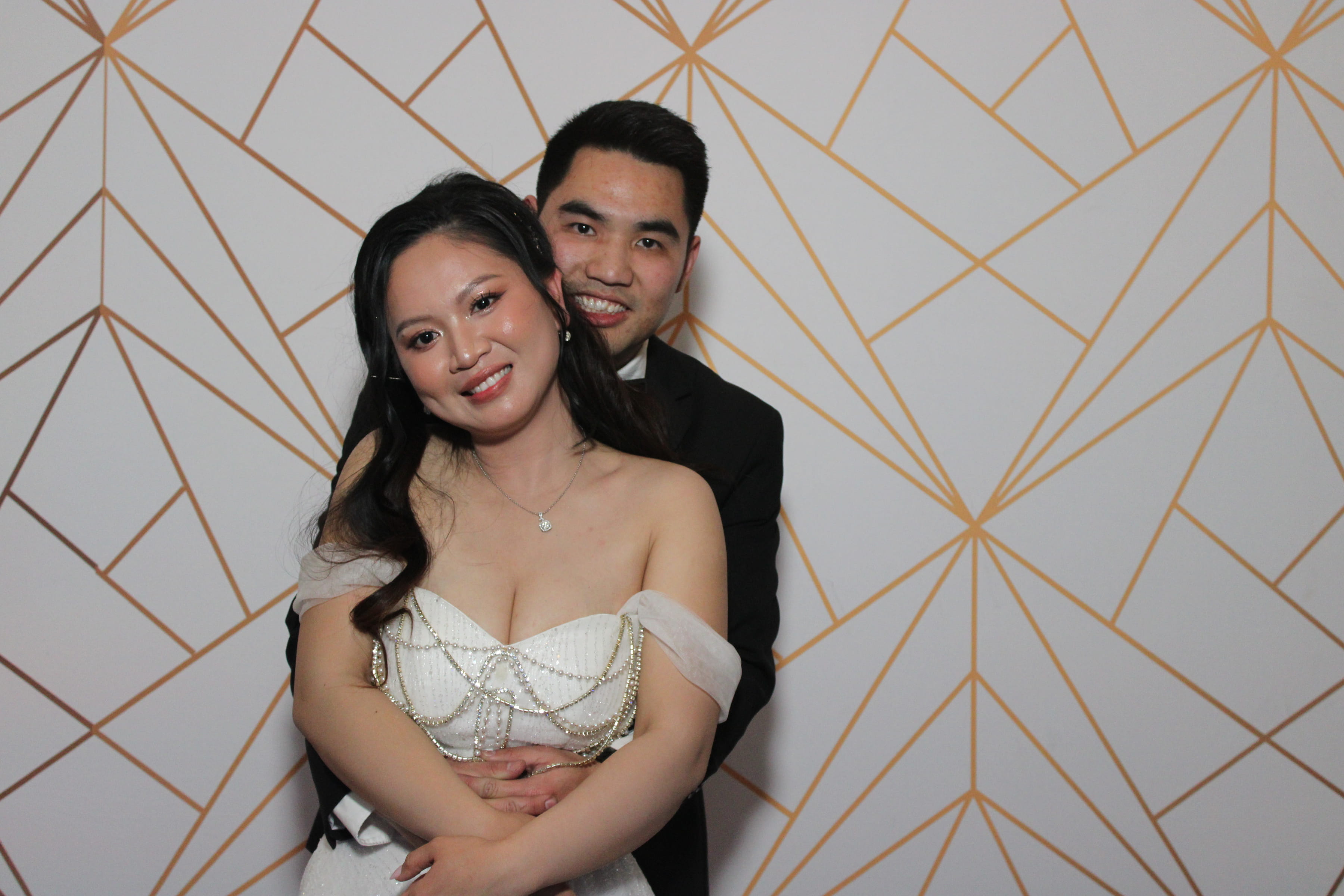Bride and groom on gold geometric backdrop